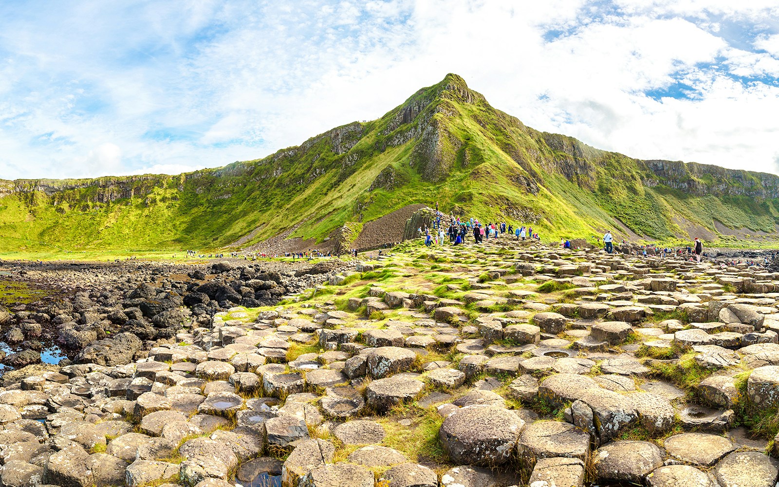 Visitors exploring the basalt columns at Giant's Causeway, Northern Ireland.