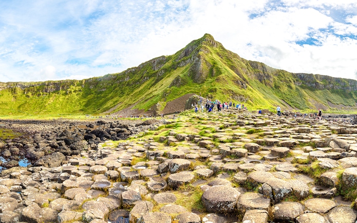Visitors exploring the basalt columns at Giant's Causeway, Northern Ireland.