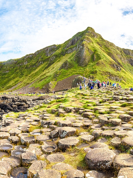 Visitors exploring the basalt columns at Giant's Causeway, Northern Ireland.