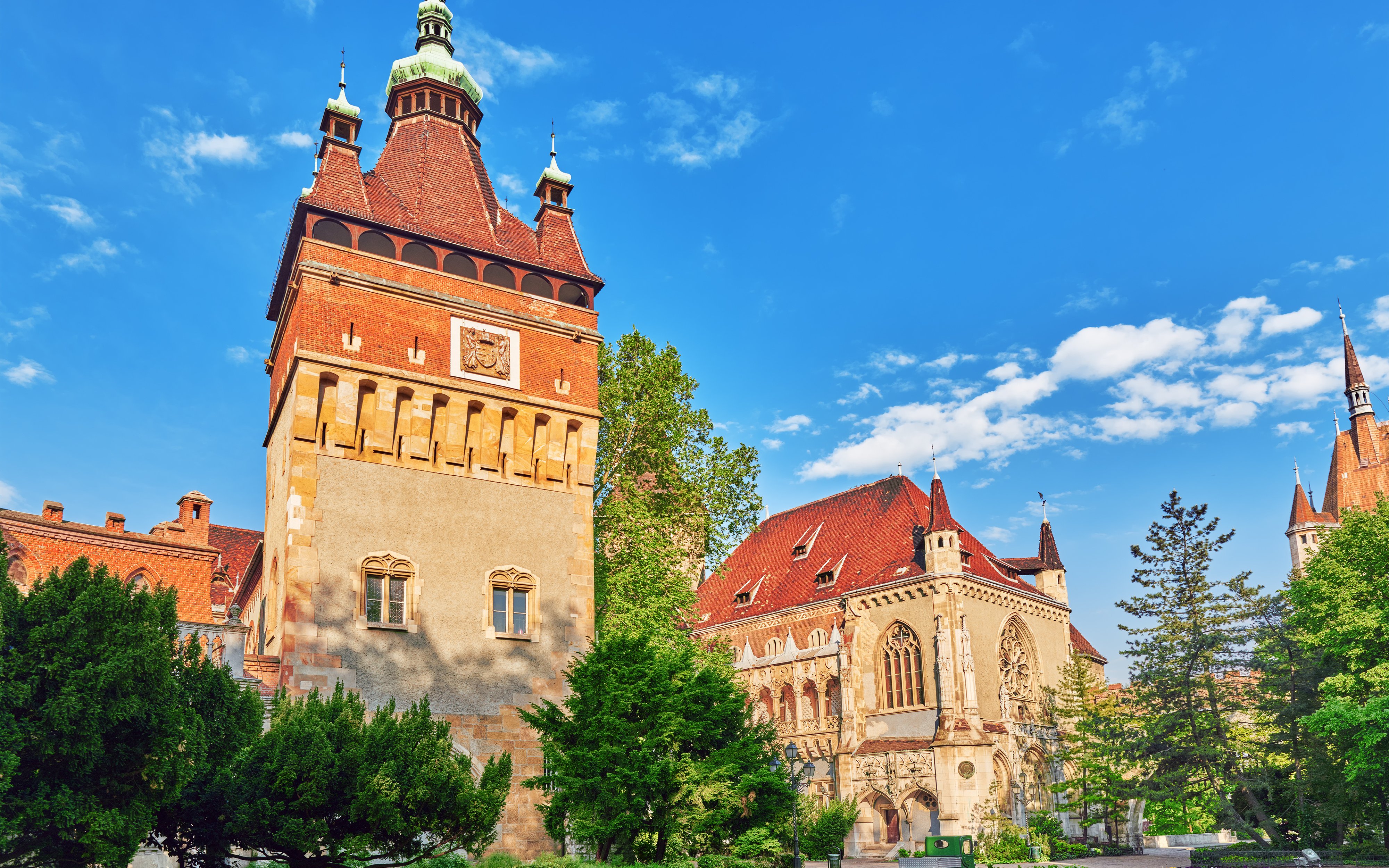 Apostles tower at Vajdahunyad Castle museum, Budapest, with ornate architecture and red roofs.