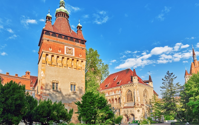 Apostles tower at Vajdahunyad Castle museum, Budapest, with ornate architecture and red roofs.