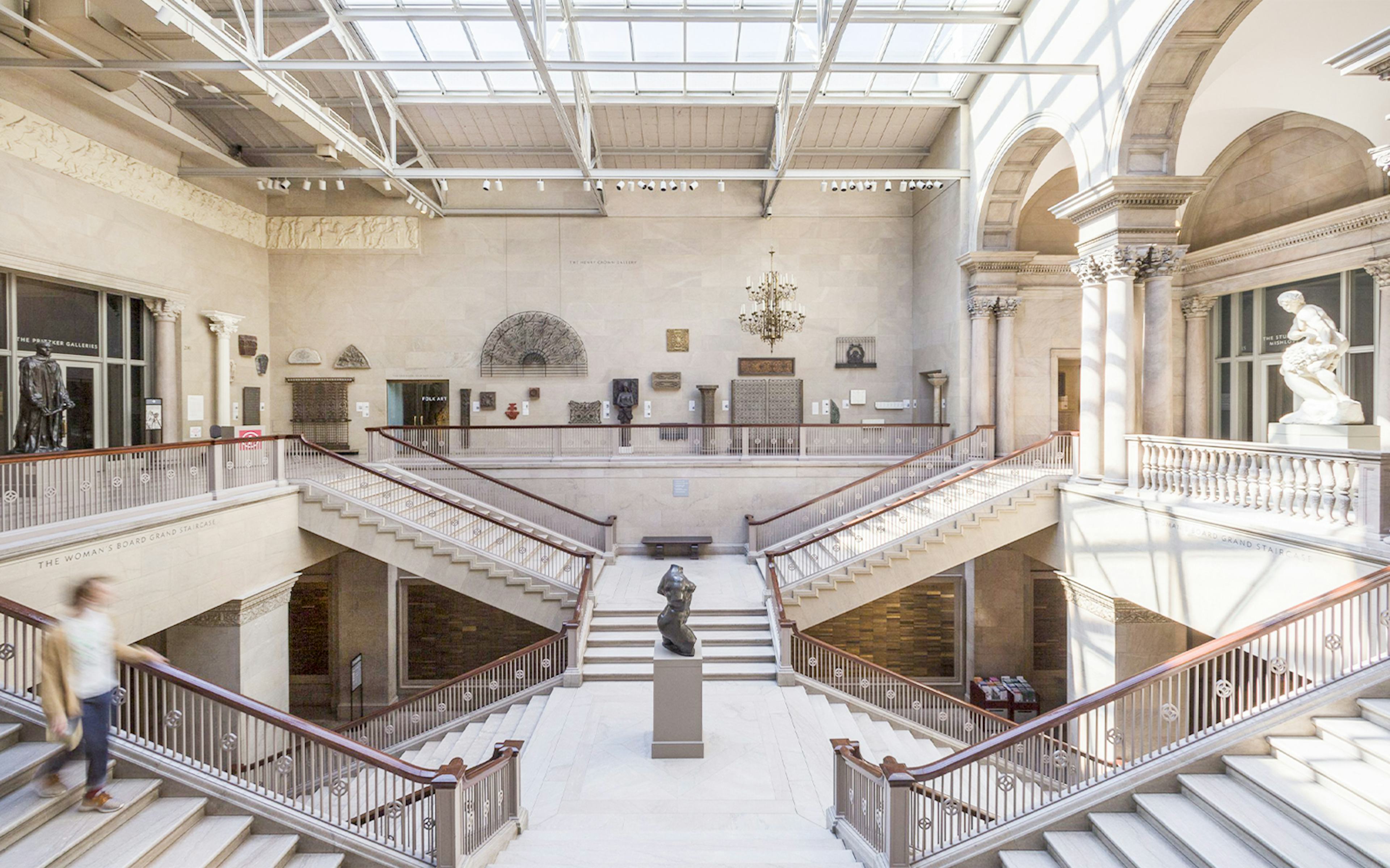 Grand staircase and sculptures at The Art Institute of Chicago hallway.