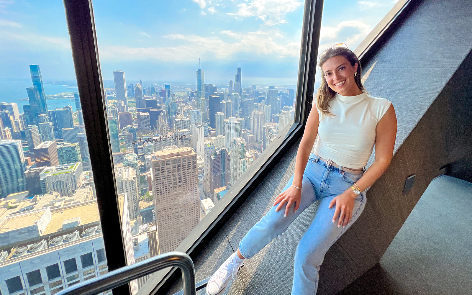 A girl at the Observation Desk of 360 Chicago, posing for the camera.