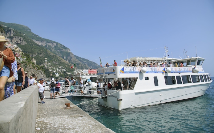 Tourists boarding a boat for an Amalfi Coast and Ravello tour from Sorrento.