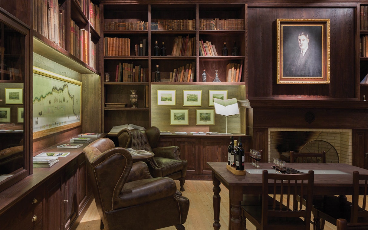 Graham’s Port Lodge library with leather chairs, wine bottles, and historical decor for a guided tour.