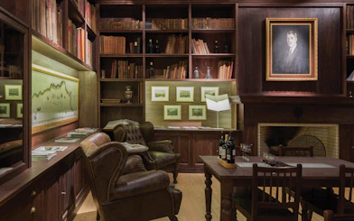 Graham’s Port Lodge library with leather chairs, wine bottles, and historical decor for a guided tour.