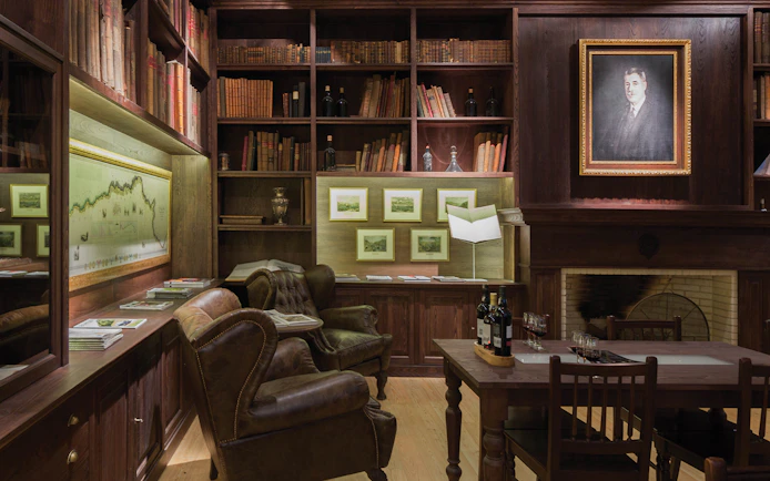 Graham’s Port Lodge library with leather chairs, wine bottles, and historical decor for a guided tour.