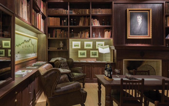 Graham’s Port Lodge library with leather chairs, wine bottles, and historical decor for a guided tour.