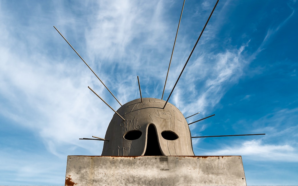 Sculpture with rods at Castel Sant'Elmo exhibit against blue sky.