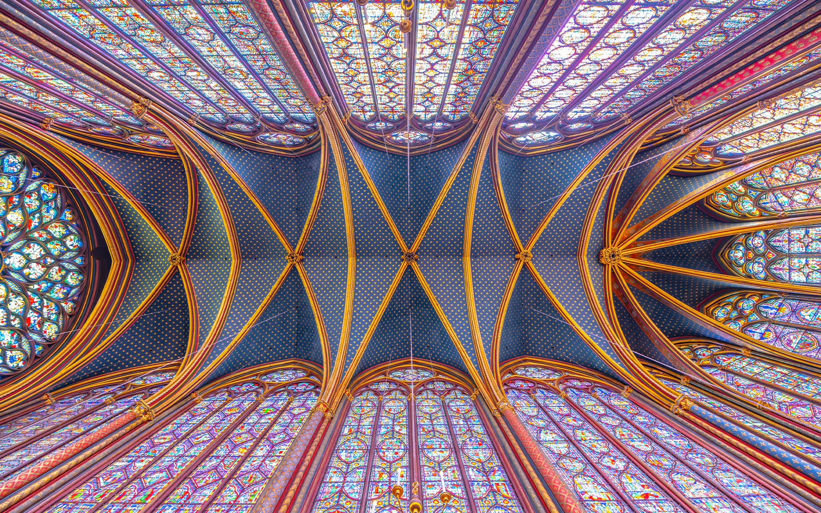 Sainte-Chapelle stained glass ceiling and arches during guided tour in Paris.