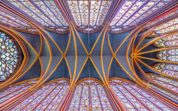 Sainte-Chapelle stained glass ceiling and arches during guided tour in Paris.