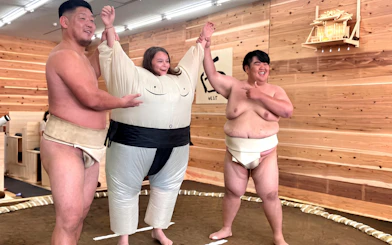 Sumo wrestlers and participant in costume at Kyoto live sumo show.
