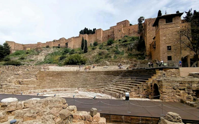 Roman Theatre ruins with Alcazaba fortress in the background, Malaga.