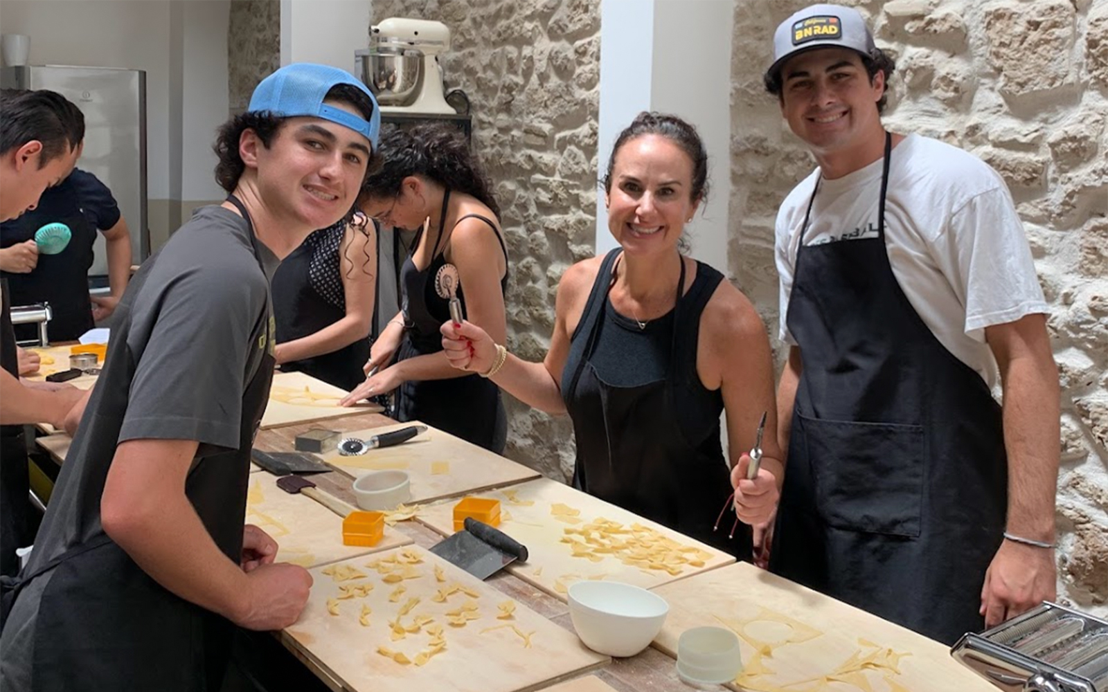 Participants making pasta in a Rome cooking class.