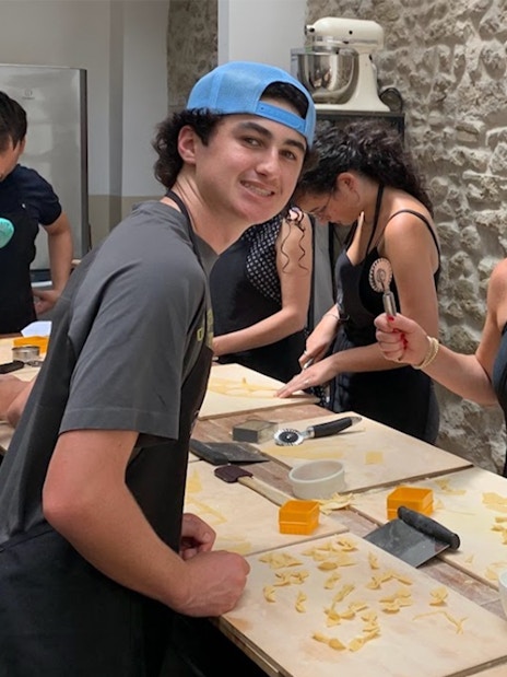Participants making pasta in a Rome cooking class.