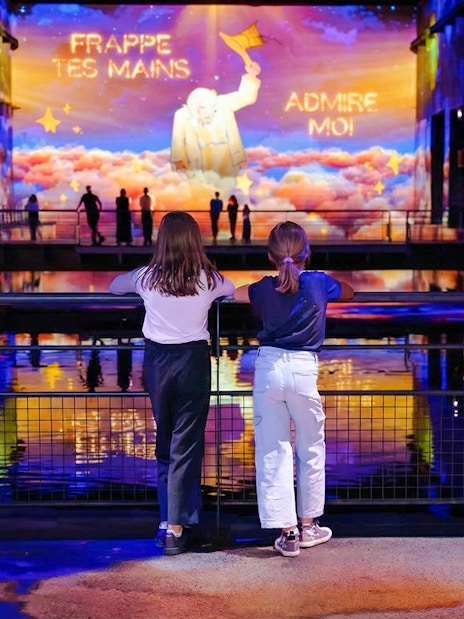 Children watching "The Little Prince" light show at Bassins des Lumières, Bordeaux.