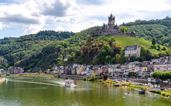Cochem Castle overlooking the Moselle River with a cruise boat, seen from 1-Hour Panorama Cruise.
