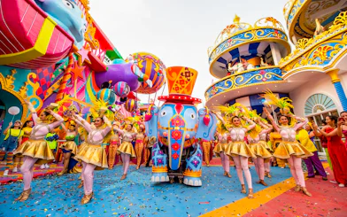 Carnival performers and colorful elephant float at Carnival Magic, Phuket.
