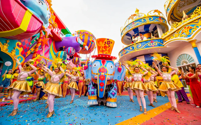 Carnival performers and colorful elephant float at Carnival Magic, Phuket.