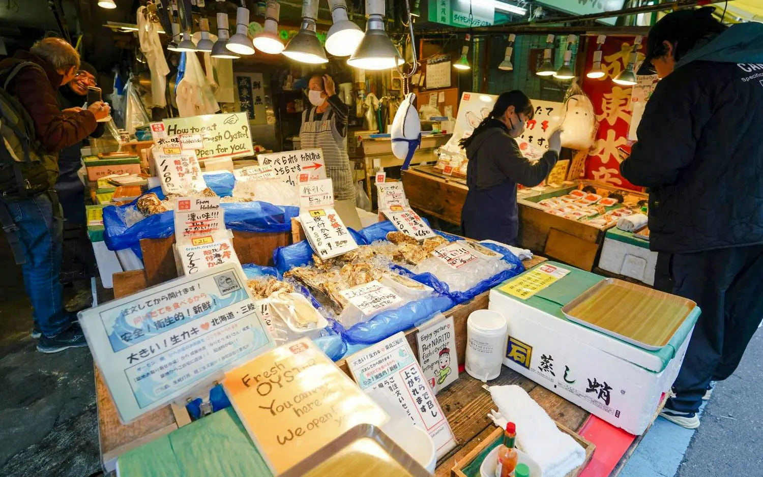 Vendors selling fresh seafood at Tsukiji Fish Market in Tokyo.