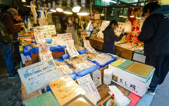 Vendors selling fresh seafood at Tsukiji Fish Market in Tokyo.