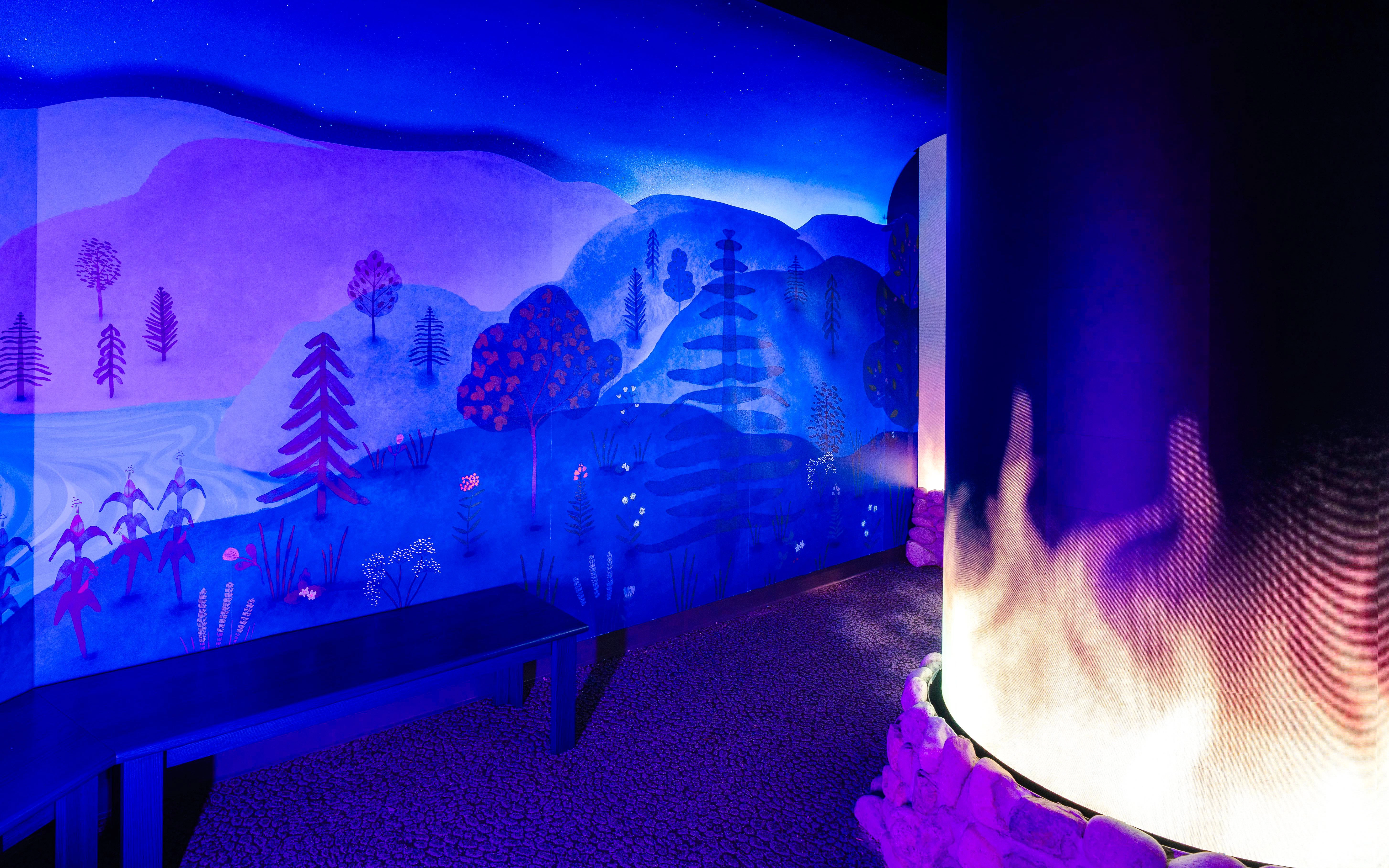 Interactive exhibit with illuminated landscape mural at Niagara Takes Flight, Canada.