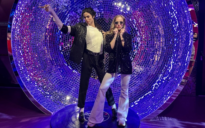 Wax figures at Madame Tussauds Budapest with a disco-themed backdrop.