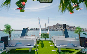 Cruise boat deck with seating, view of Ibiza town during Ibiza to Formentera cruise.