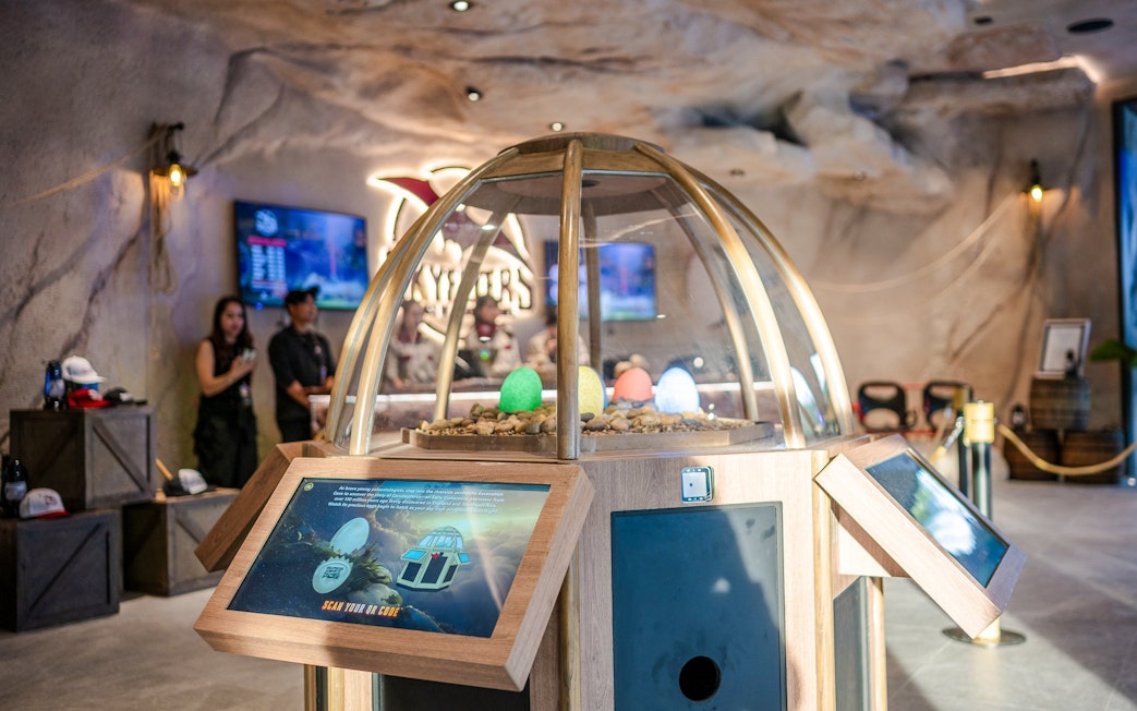 Interactive exhibit at SkyFlyers Asiatique Bangkok with colorful eggs under a glass dome.
