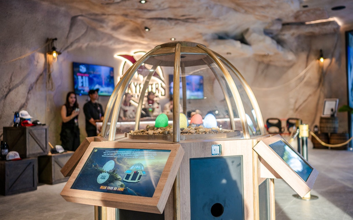 Interactive exhibit at SkyFlyers Asiatique Bangkok with colorful eggs under a glass dome.
