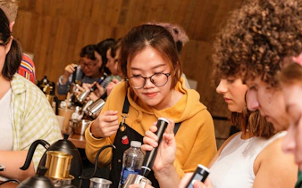 Participants learning to make Vietnamese egg coffee in a workshop.