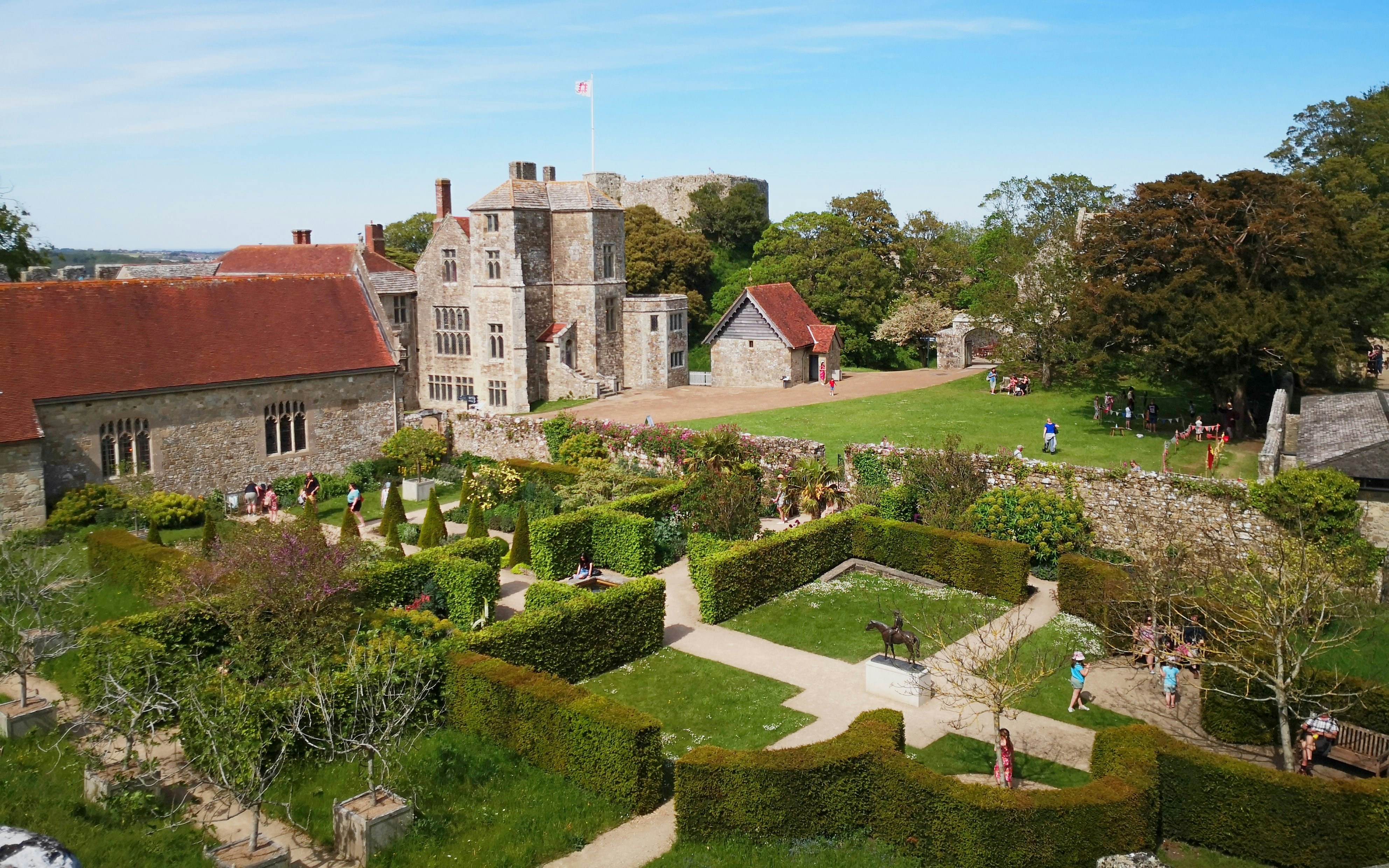 Carisbrooke Castle gardens and historic buildings on a sunny day, Isle of Wight, England.