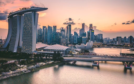 Singapore skyline at sunset with Marina Bay Sands and ArtScience Museum.