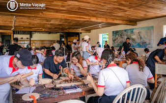 Participants carving wood at Driftwood Village workshop, Hoi An.