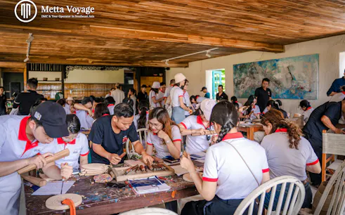 Participants carving wood at Driftwood Village workshop, Hoi An.