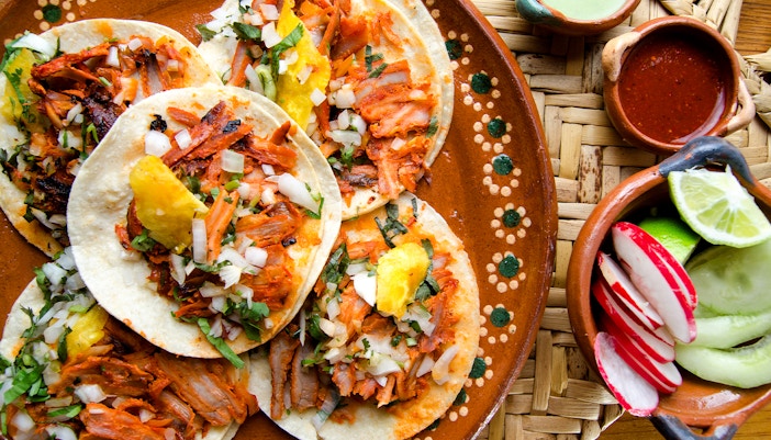 Traditional tacos al pastor with pineapple and cilantro