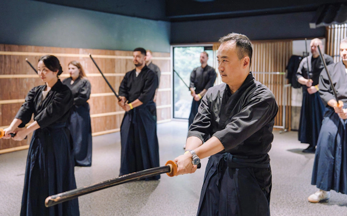 Participants practicing sword techniques at Samurai Museum Tokyo in Shinjuku.