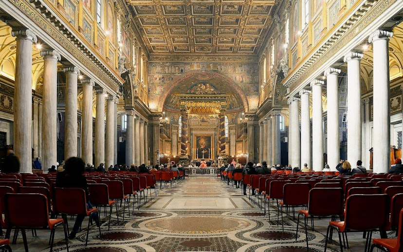 Interior of Papal Basilica of Santa Maria Maggiore, Rome, with ornate ceiling and columns.