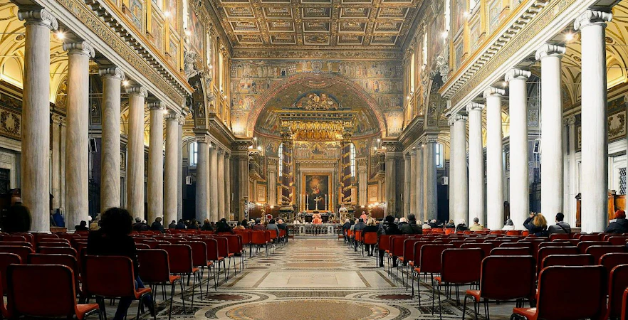 Interior of Papal Basilica of Santa Maria Maggiore, Rome, with ornate ceiling and columns.