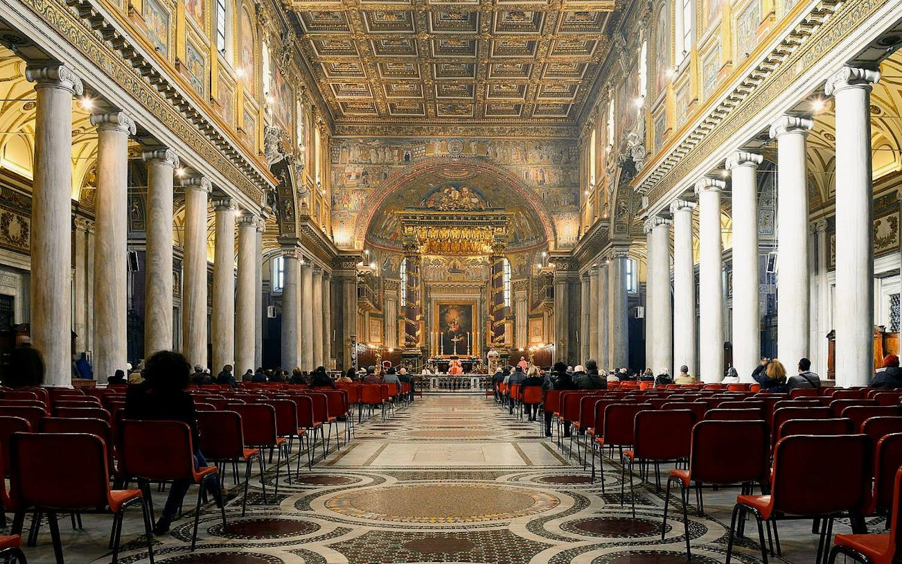 Interior of Papal Basilica of Santa Maria Maggiore, Rome, with ornate ceiling and columns.
