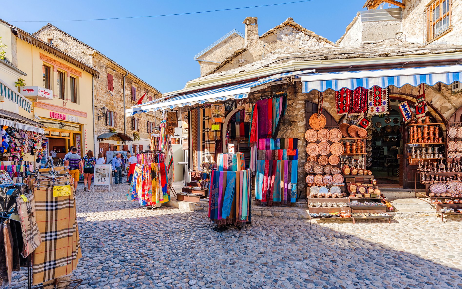 Old town shops with colorful textiles and crafts in Mostar, Dubrovnik.