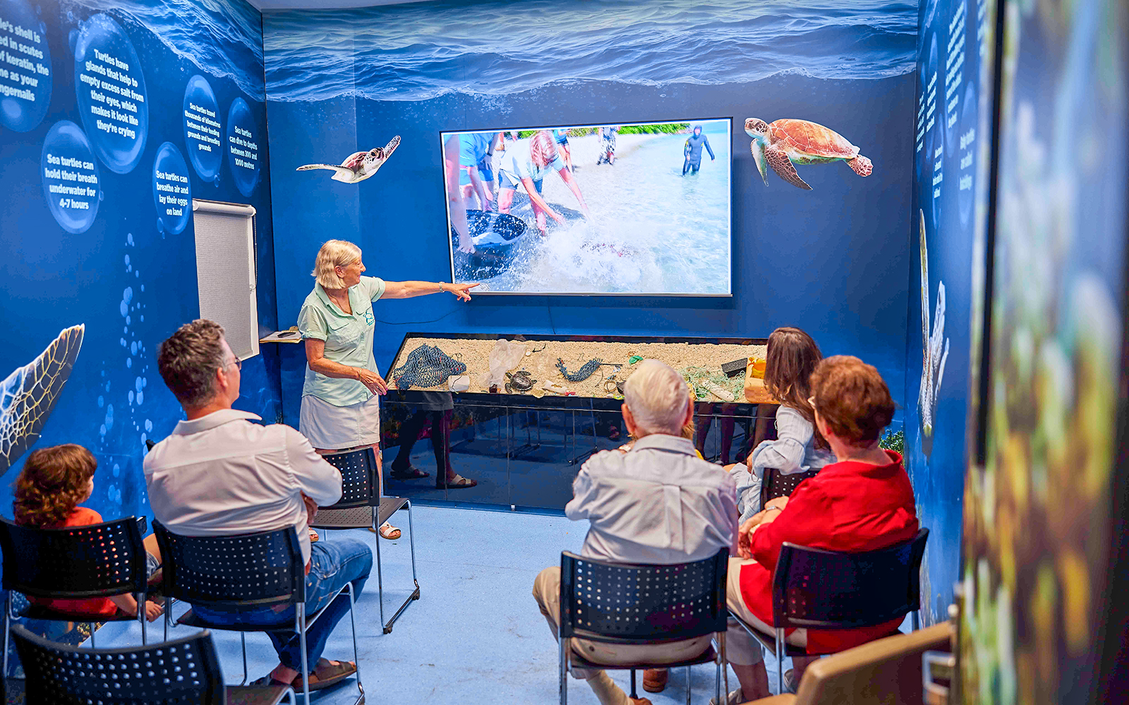 Visitors attending a presentation at Cairns Aquarium Turtle Hospital.