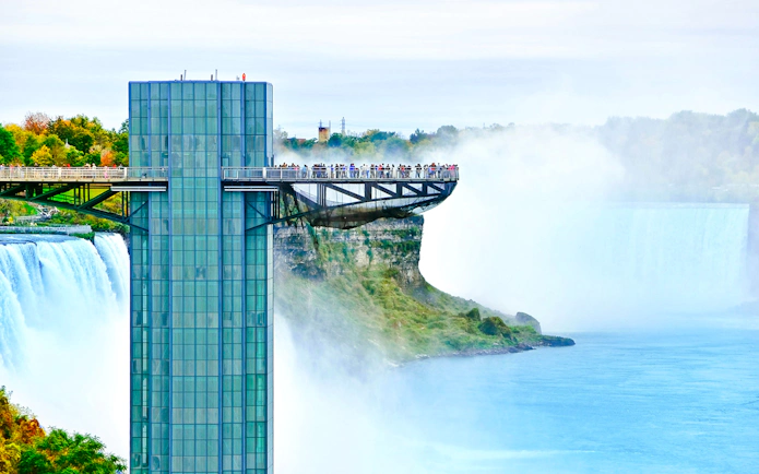 Prospect Point observation deck overlooking Niagara Falls, USA, with mist and river below.