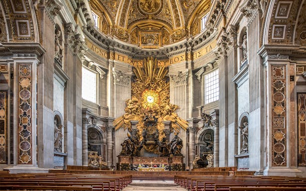 St. Peter's Basilica altar with ornate sculptures and golden rays in Vatican City.