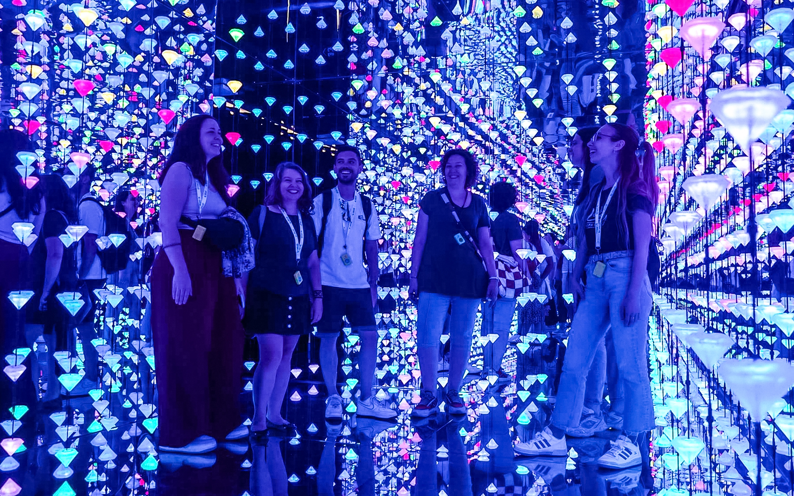 Visitors enjoying digital art exhibit at Moco Museum.