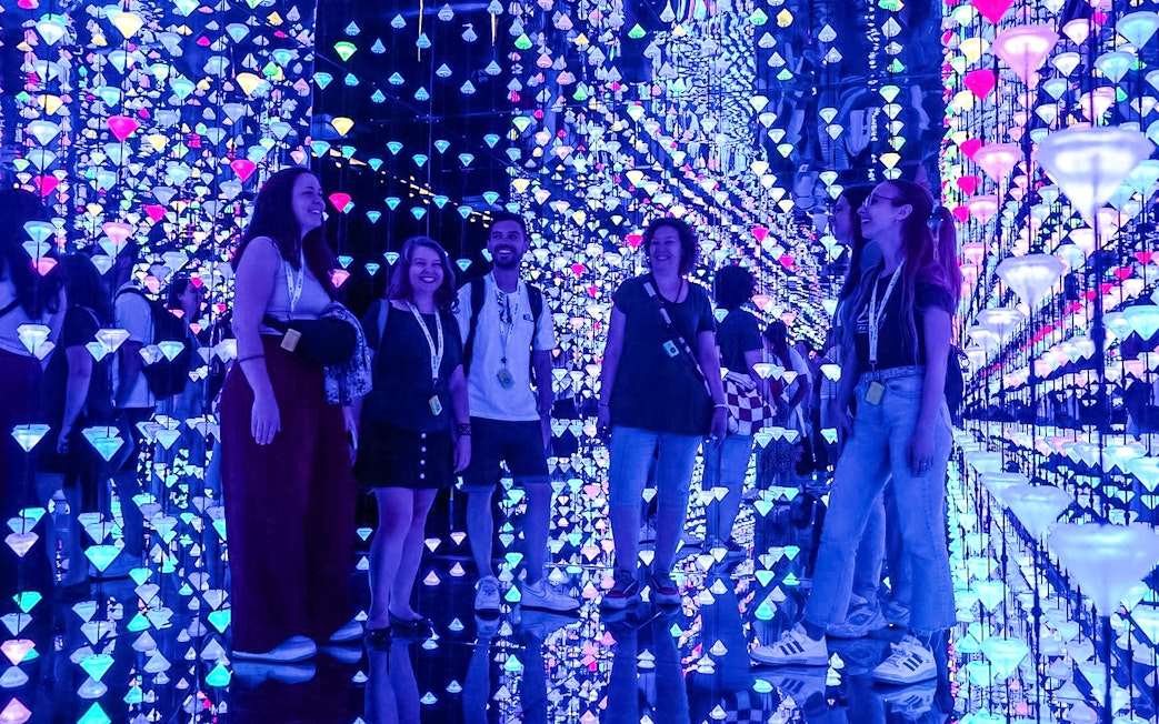 Visitors enjoying digital art exhibit at Moco Museum.