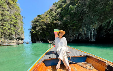 Longtail boat tour through Hong Islands, Krabi, with limestone cliffs and turquoise water.