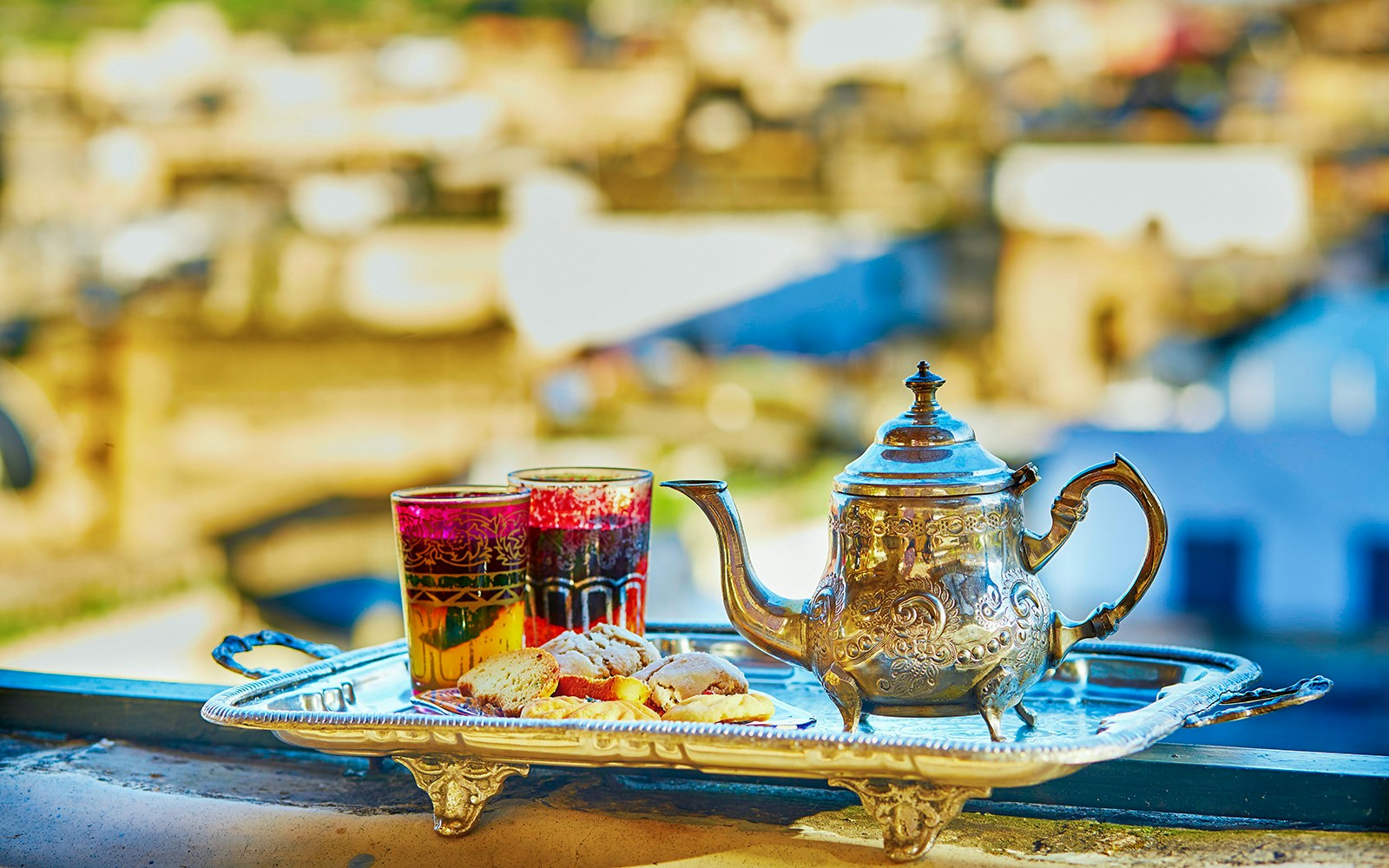Silver teapot and glasses with pastries on a tray, Traditional Treatment Hammam & Spa.