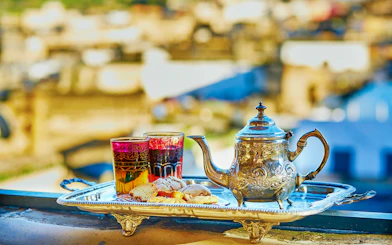 Silver teapot and glasses with pastries on a tray, Traditional Treatment Hammam & Spa.