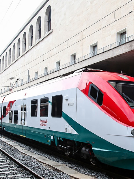 Leonardo Express train at Rome Termini Station platform, connecting to Fiumicino Airport.
